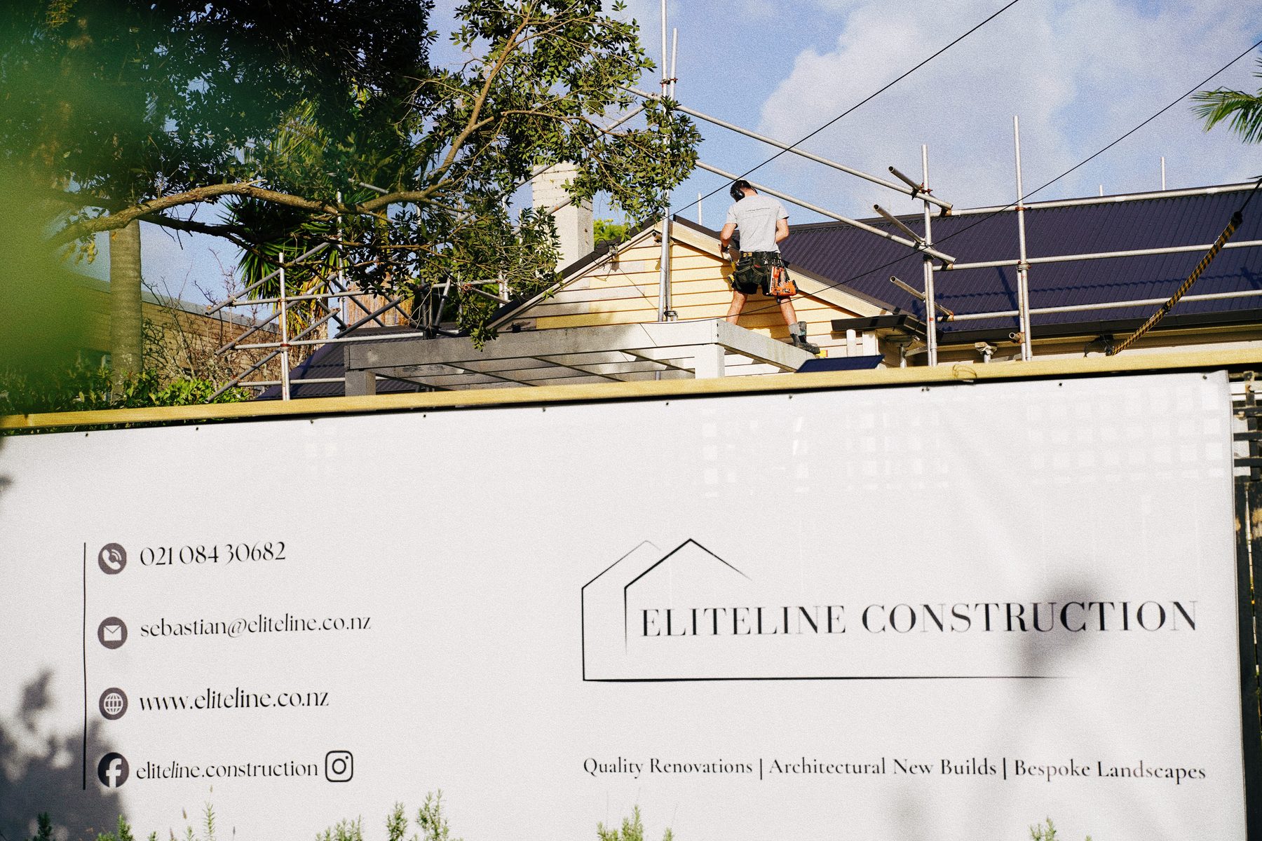 EliteLine Construction site signage with roof work underway behind