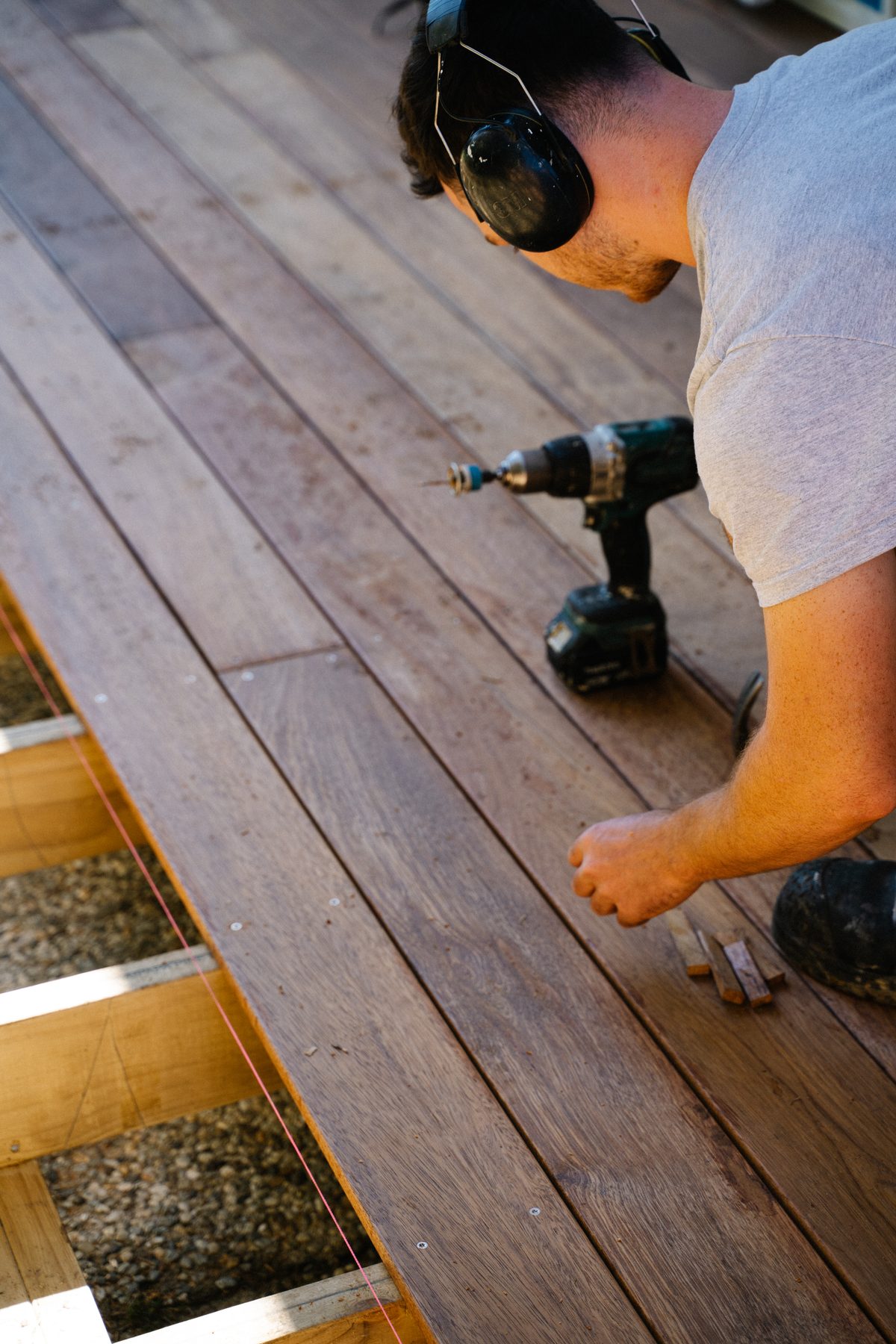 Carpenter fixing deck boards