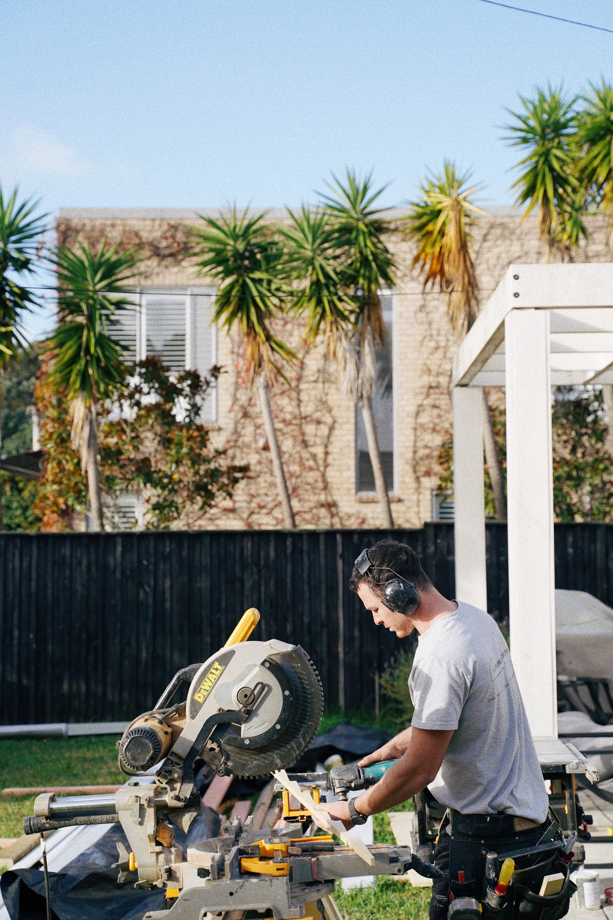 Carpenter cutting timber on a mitre saw