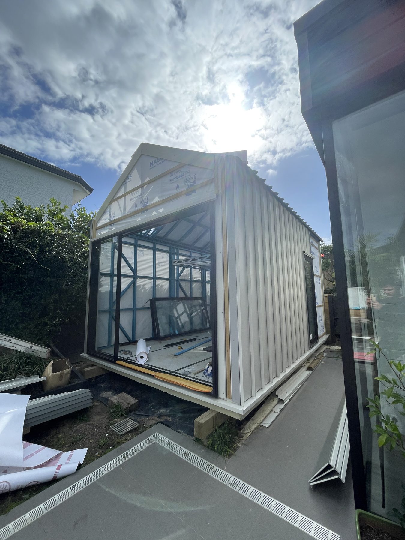 Sleepout exterior with corrugated cladding and glass sliding doors going in