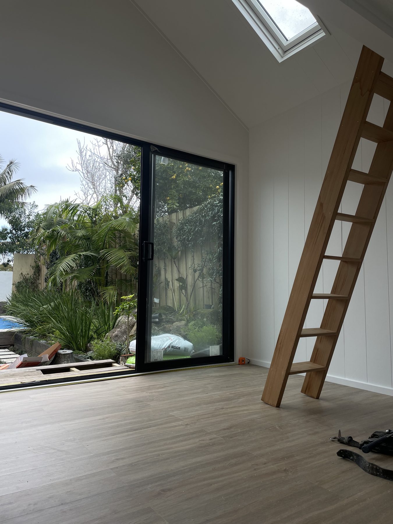 Finished sleepout interior with built-in loft ladder