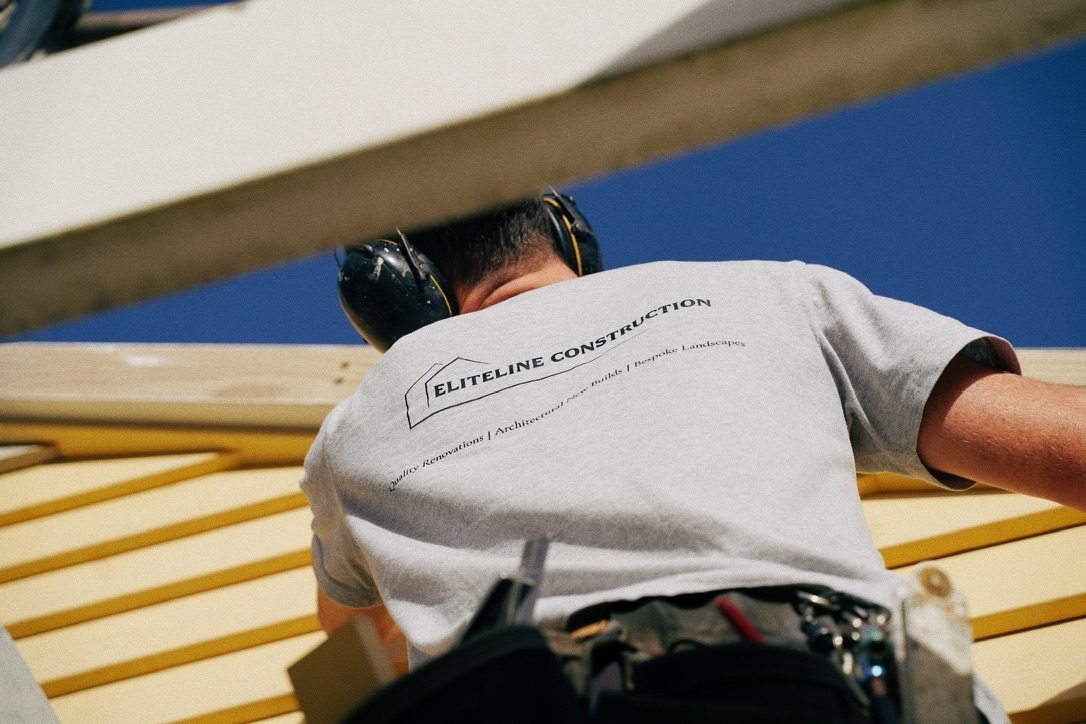 EliteLine Construction crew member on the roof